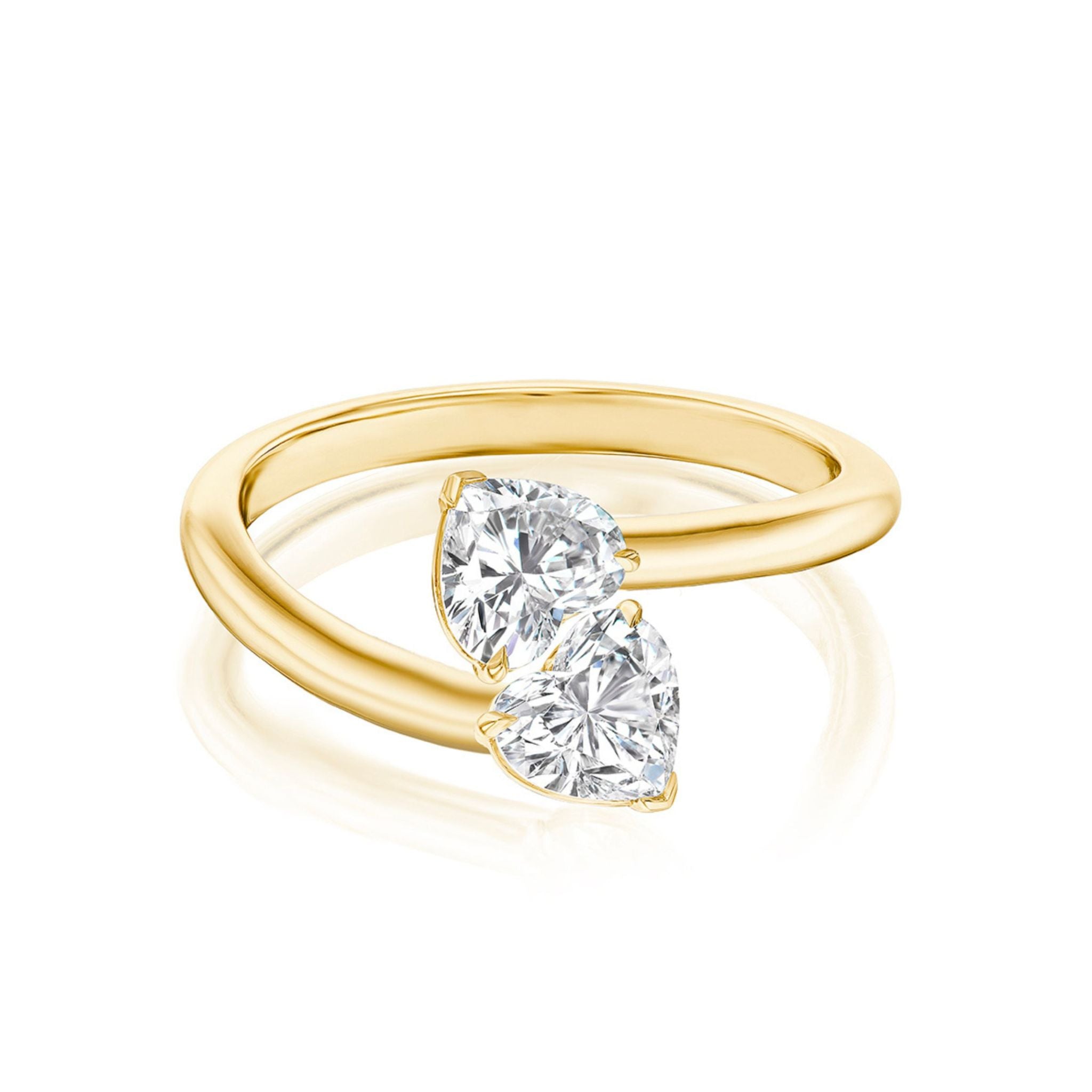 The Double Heart Wrap Around Ring, crafted in 18k yellow gold, showcases two heart-shaped clear gemstones of SI2 clarity set side by side on a split band, photographed against a white background.