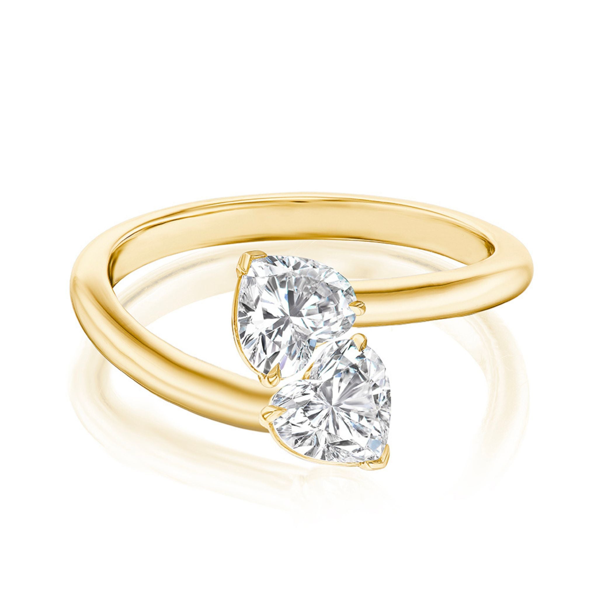 The Double Heart Wrap Around Ring in 18K yellow gold features an open band with two heart-shaped SI2 clarity diamonds facing each other at the ends.