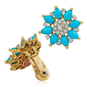 The Marchak Turquoise and Diamond Earclips are 18K yellow gold, flower-shaped earrings with turquoise cabochon petals, clear gemstones, and a central diamond cluster. One earring shows the front; the other reveals the clip-on backing.