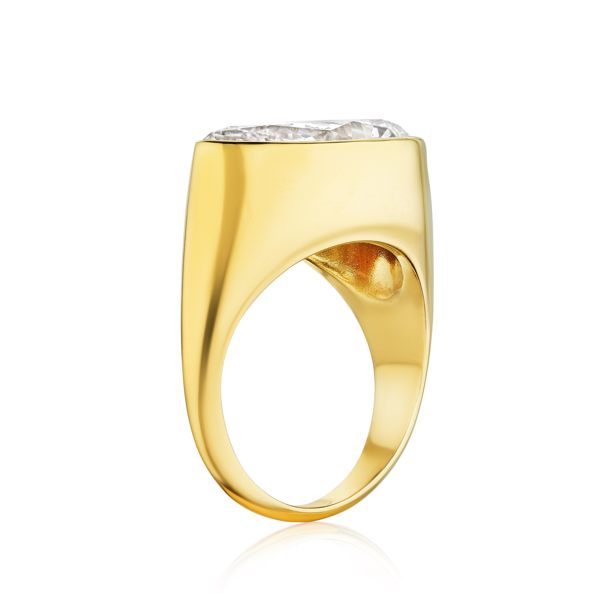 The East-West Bezel Set Pear Shape Diamond Ring in Yellow Gold features a wide, smooth band and a prominent bezel-set diamond, shown from the side on a white background.