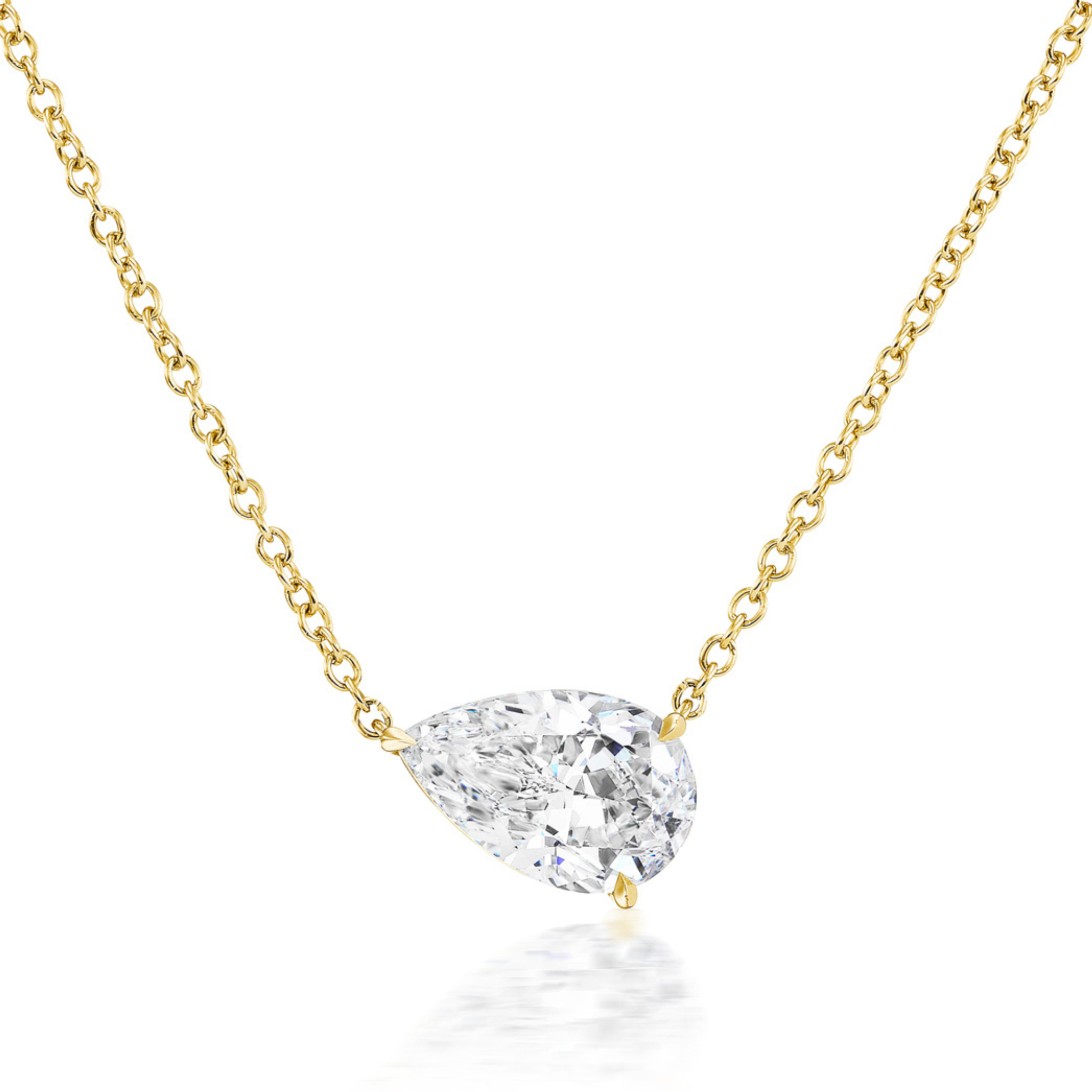 The East-West Diamond Set Pear Pendant Necklace features a pear brilliant diamond in a minimalist setting on an 18-inch 18K yellow gold chain, displayed against a white background.