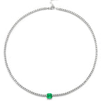 The Classic Tennis Necklace with an Asscher Cut Emerald in White Gold features a square Asscher Cut emerald gemstone centerpiece and petite clear stones, beautifully showcased against a white background.