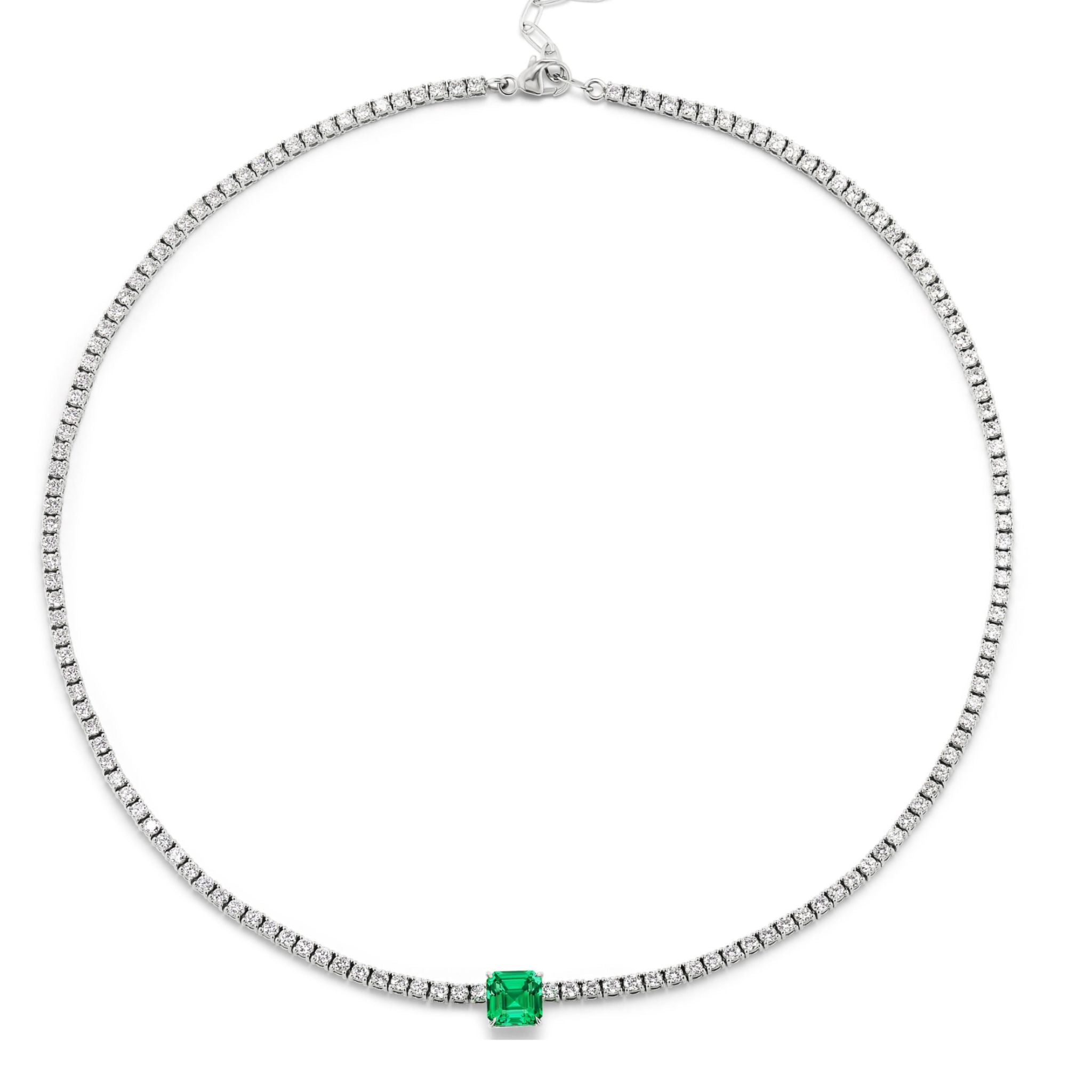 The Classic Tennis Necklace with an Asscher Cut Emerald in White Gold features a square Asscher Cut emerald gemstone centerpiece and petite clear stones, beautifully showcased against a white background.