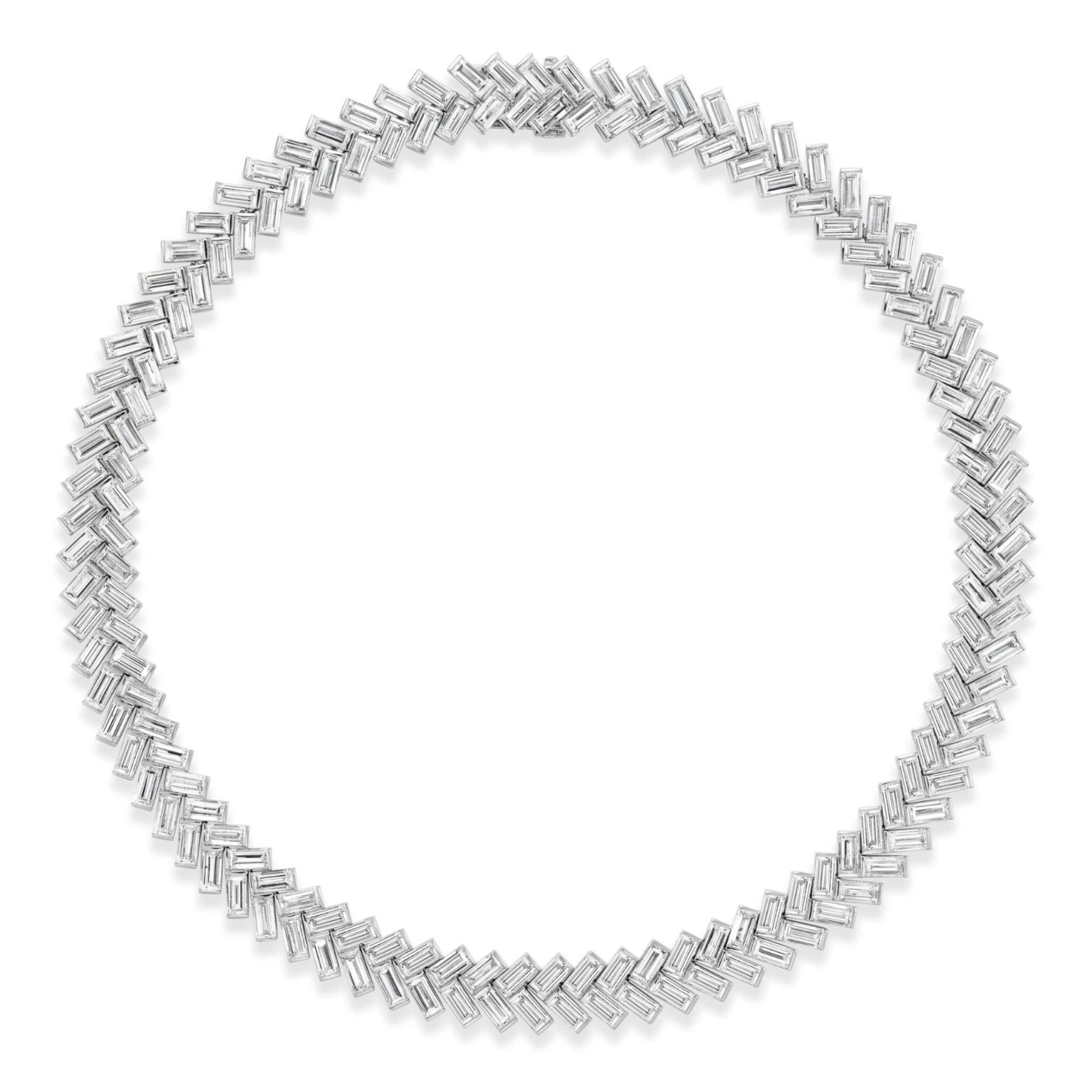 Bezel Set Chevron Diamond Tennis Necklace in White Gold features overlapping baguette-cut diamonds set in a striking chevron pattern, creating a seamless circular chain against a white backdrop. Expertly crafted from luxurious 18K white gold, each hand-selected baguette diamond boasts VVS1-VS1 clarity for exceptional brilliance and refined elegance.
