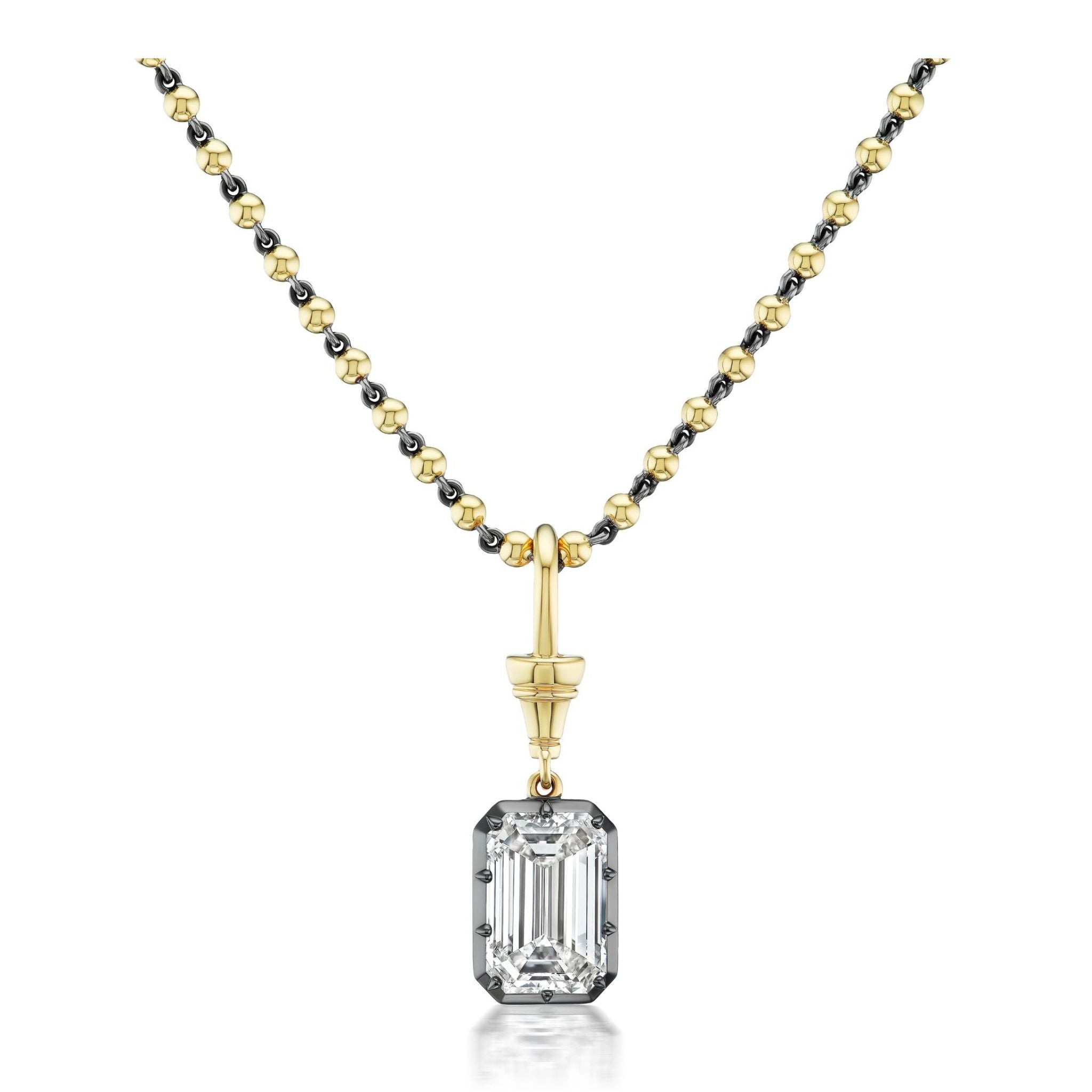 Collet Set Emerald Cut Diamond in Black Rhodium and Yellow Gold, featuring a gold and black beaded chain necklace with a rectangular emerald cut diamond pendant, elegantly displayed on a white background.