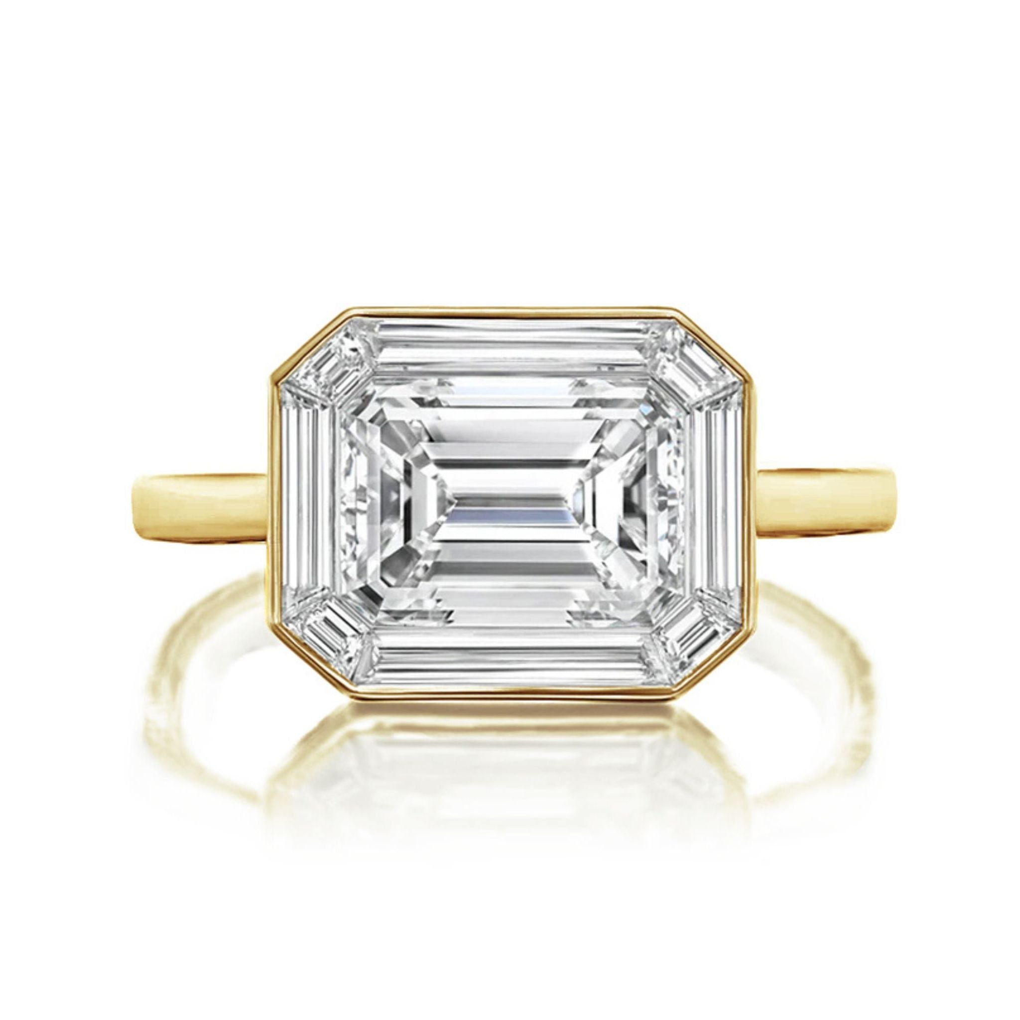 An East-West Set Mosaic Diamond Engagement Ring featuring an emerald-cut diamond with a baguette halo in white gold, displayed from above against a white background.