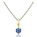 Collet Set Heart Shape Blue Sapphire Necklace in Black Rhodium and Yellow Gold showcases alternating gold and black rhodium beads, highlighted by a yellow gold pendant that holds a captivating heart shape blue sapphire. The faceted gemstone dazzles on a plain white backdrop, elegantly enhanced by the luxurious 18k yellow gold accents.
