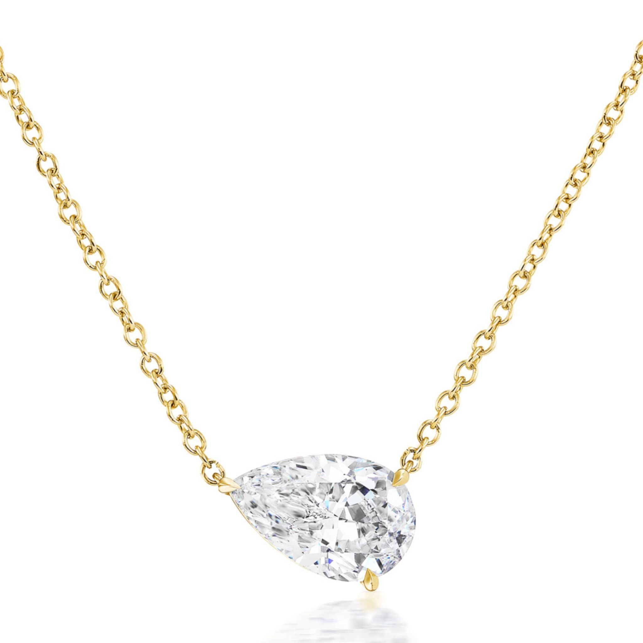 Introducing the East-West Diamond Set Pear Pendant Necklace—crafted in 18k yellow gold, this minimalist 18-inch gold chain necklace features a striking east-west set, pear-shaped clear brilliant diamond pendant. Displayed elegantly on a white background.