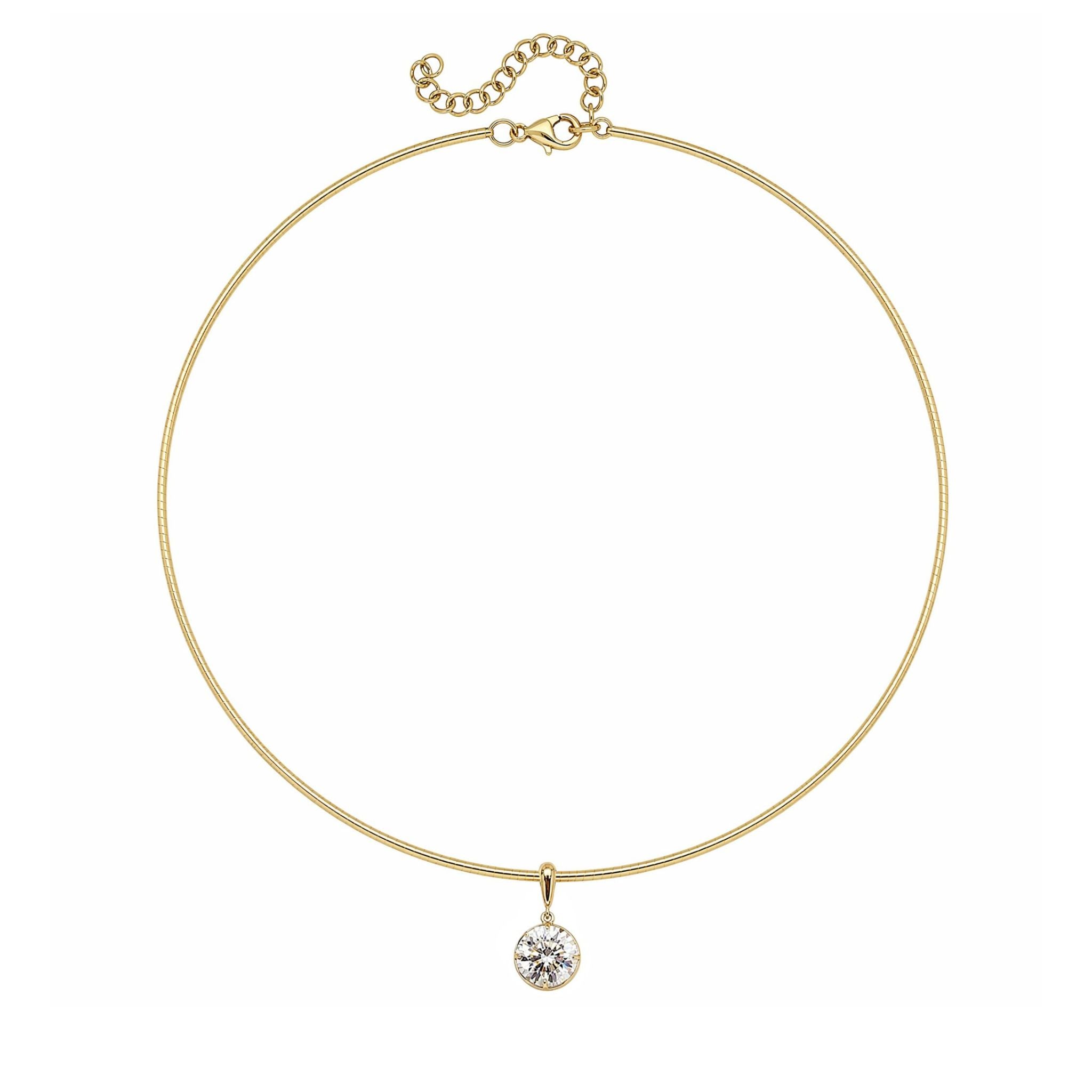 The Collet Set Round Diamond Omega Chain Necklace is crafted in thin 18k yellow gold with an adjustable clasp and features a single round diamond pendant at the center.