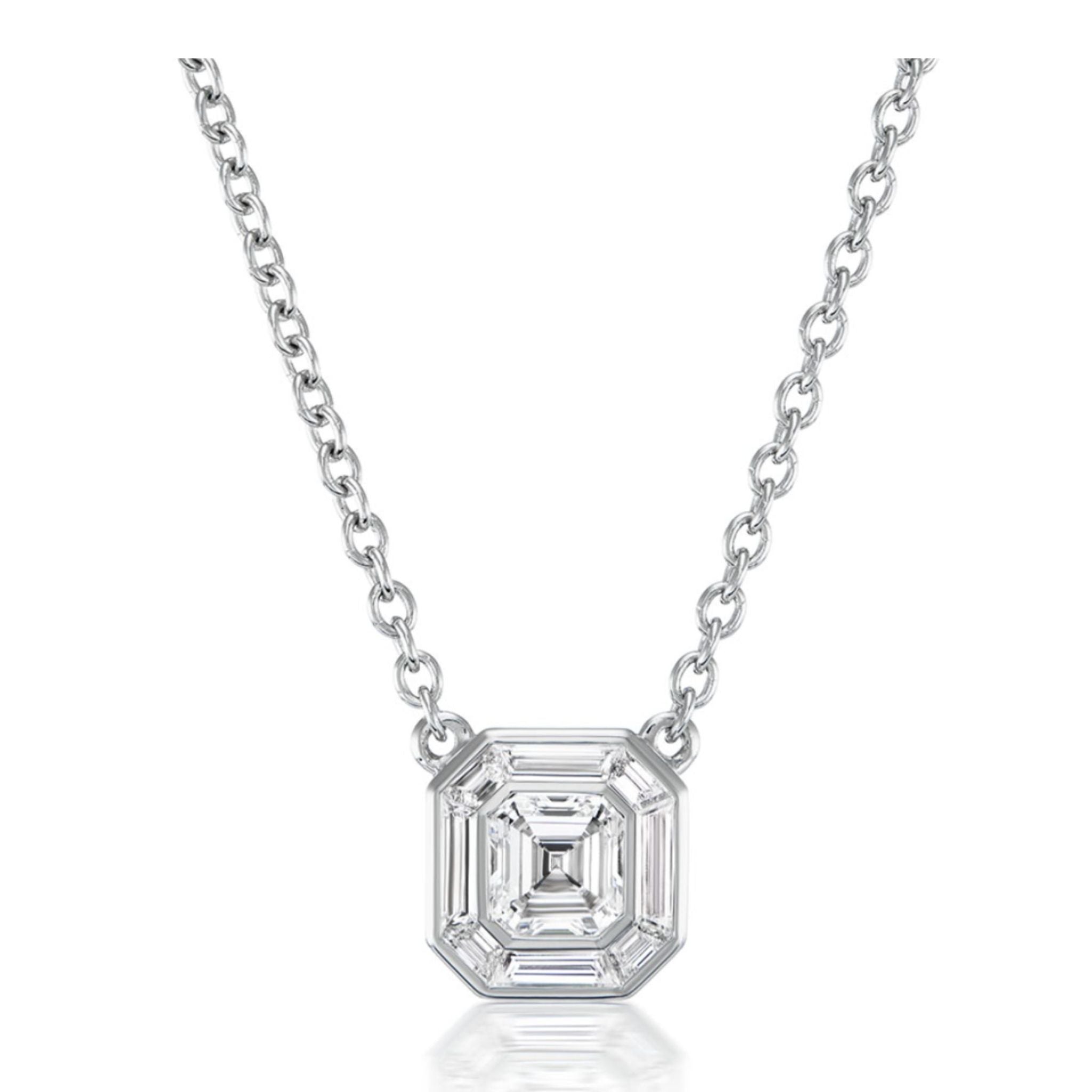 The Asscher Cut Diamond Mosaic Necklace in White Gold features a striking, large octagon-shaped clear gemstone with step-cut facets, reminiscent of an Asscher cut diamond, showcased on a white background.