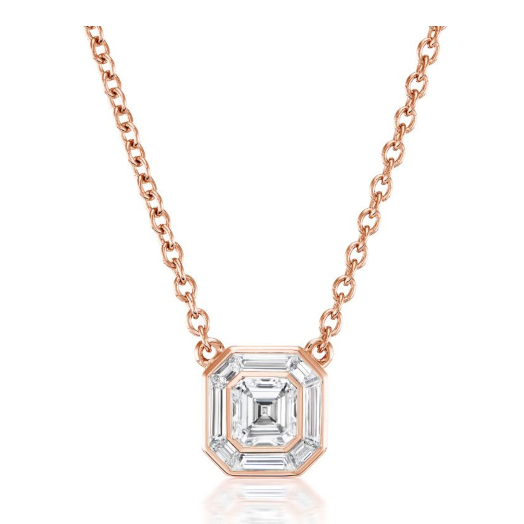 The Emerald Cut Diamond Mosaic Pendant in Rose Gold features an emerald cut diamond set in an octagonal, step-cut bezel setting and expertly crafted in 18K rose gold for a timeless Art Deco-inspired necklace, beautifully displayed on a white background.