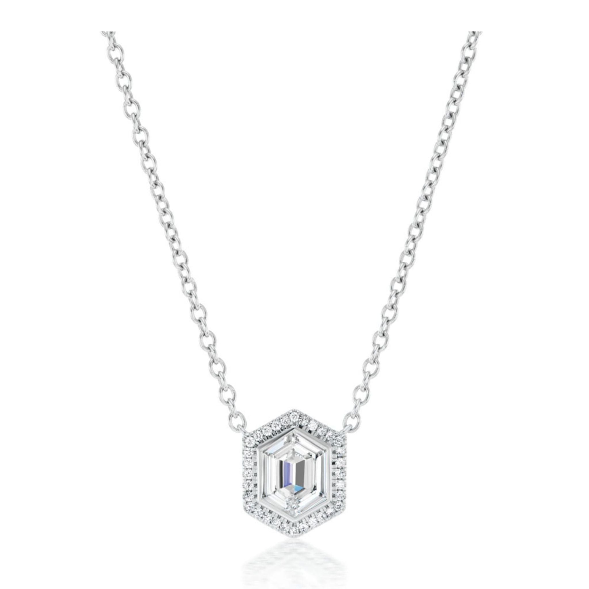 Introducing the Pavé Hexagonal Diamond Solitaire Pendant in White Gold: a stunning silver necklace showcasing a hexagon-shaped pendant with an emerald-cut centerpiece, elegantly encircled by pavé-set round diamonds on a delicate chain—this exquisite piece offers a modern, sophisticated take on the classic diamond pendant.