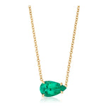 Showcased against a white background, the East-West Pear Shape Emerald Pendant in Yellow Gold features a dazzling pear-shaped emerald set in a minimalist 18K yellow gold prong setting and suspended from a gold chain necklace.
