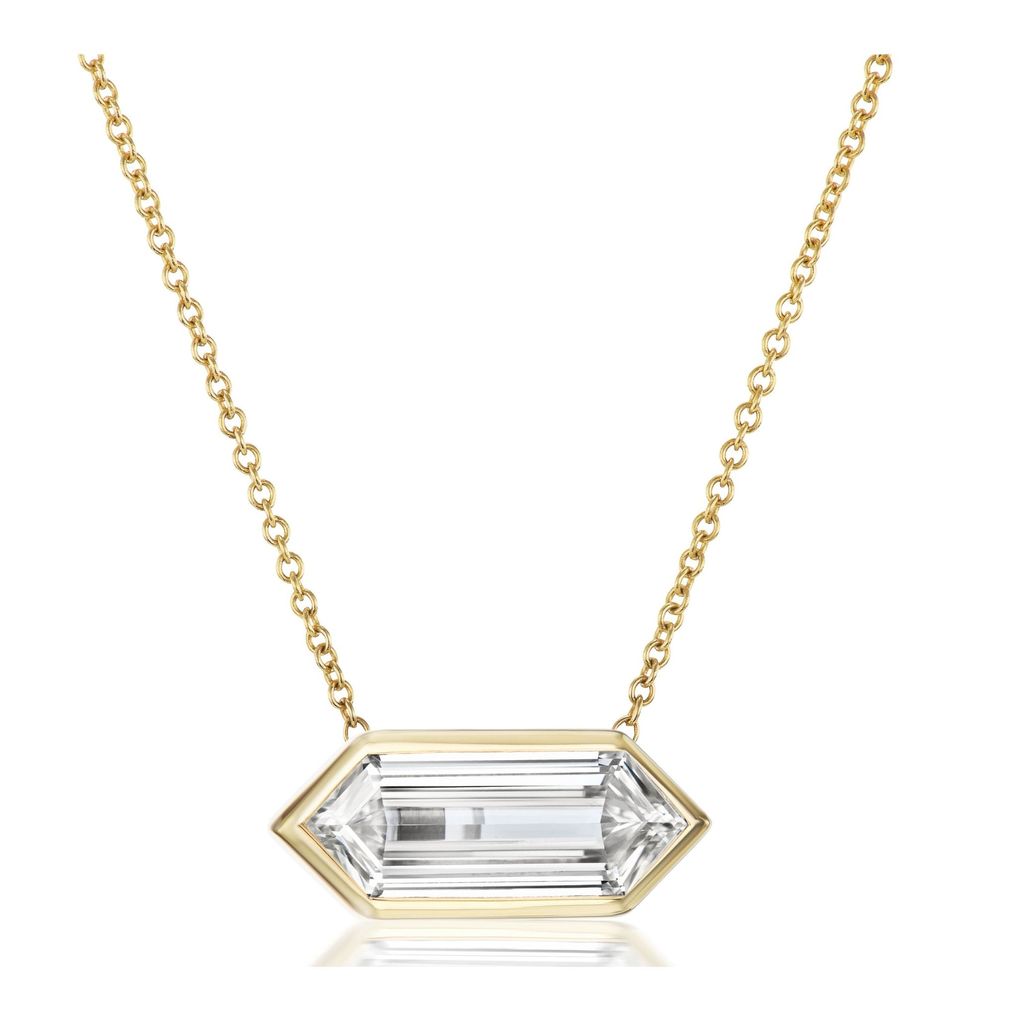 The East-West Bezel Set Lozenge Diamond Pendant Necklace in Yellow Gold showcases a horizontally set lozenge-shaped diamond in a luxurious 18k yellow gold bezel setting.