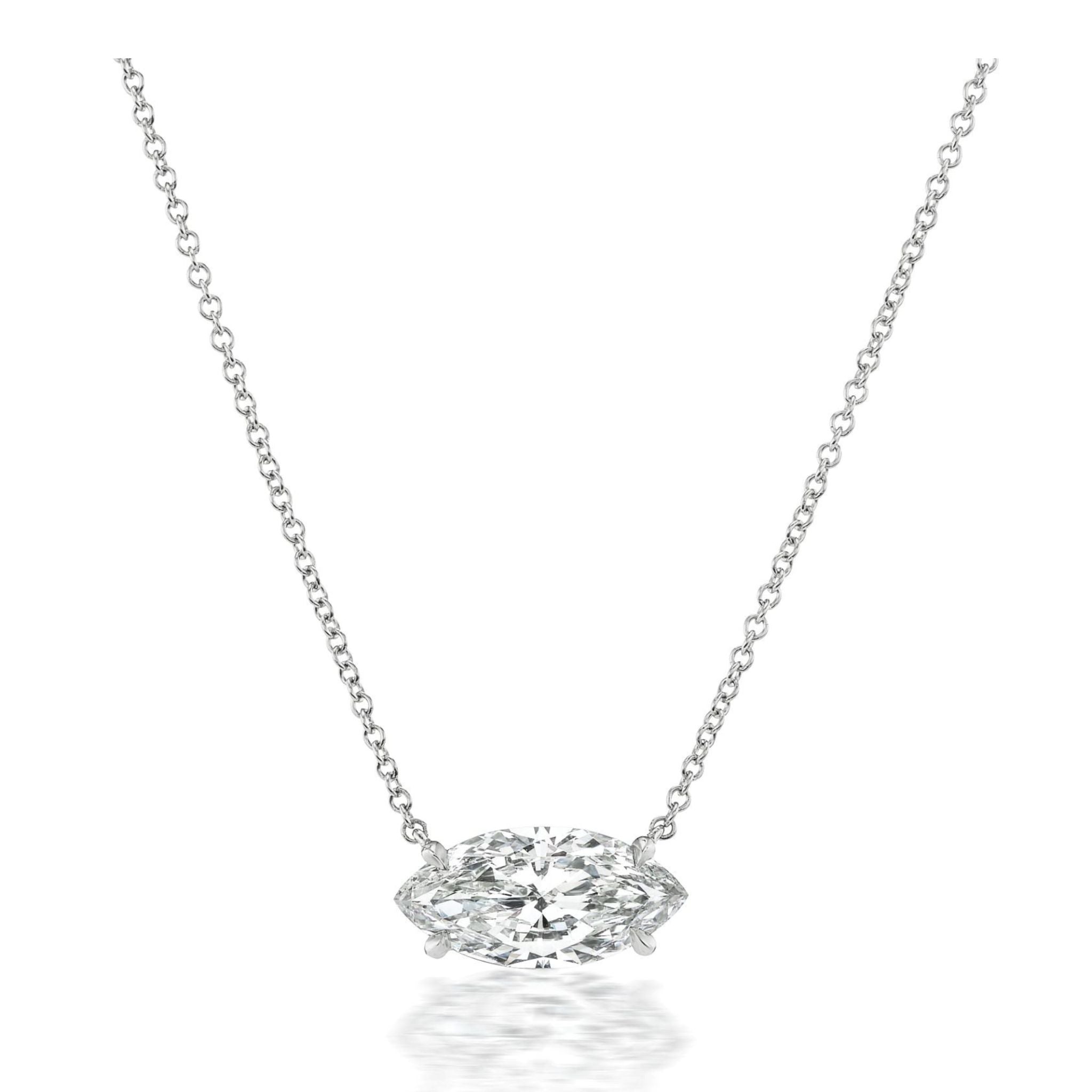 Certainly! Here’s a rewritten version using the product data: The East-West Marquise Diamond Solitaire Pendant in White Gold features a striking marquise-cut diamond set horizontally at the center of a sleek white gold chain, displayed elegantly against a plain white background.