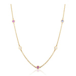 The Station Necklace in Yellow Gold features round diamonds and multicolor sapphires, each gemstone bezel-set and evenly spaced along a lustrous 18k yellow gold chain, displayed elegantly on a white background.