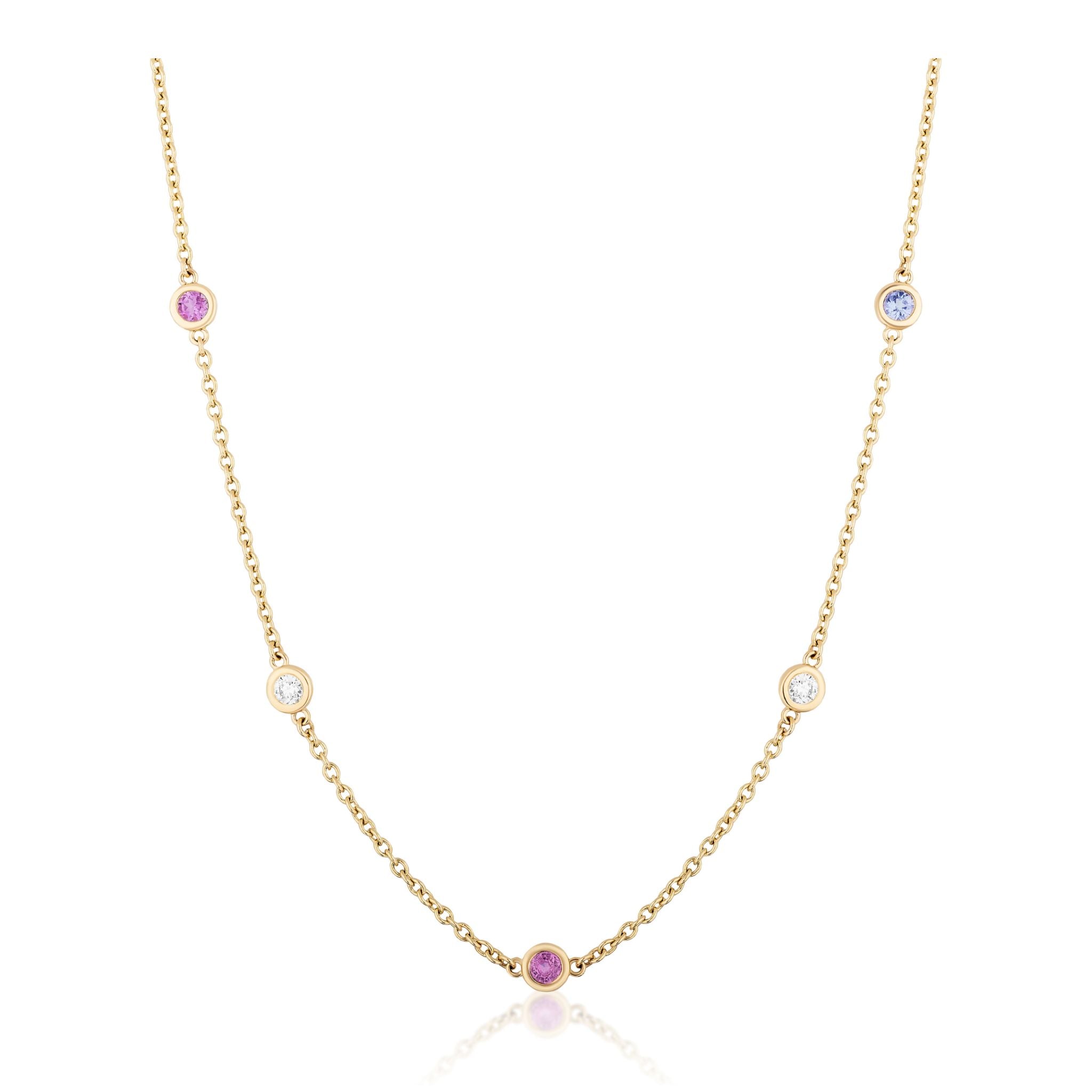 The Station Necklace in Yellow Gold features round diamonds and multicolor sapphires, each gemstone bezel-set and evenly spaced along a lustrous 18k yellow gold chain, displayed elegantly on a white background.