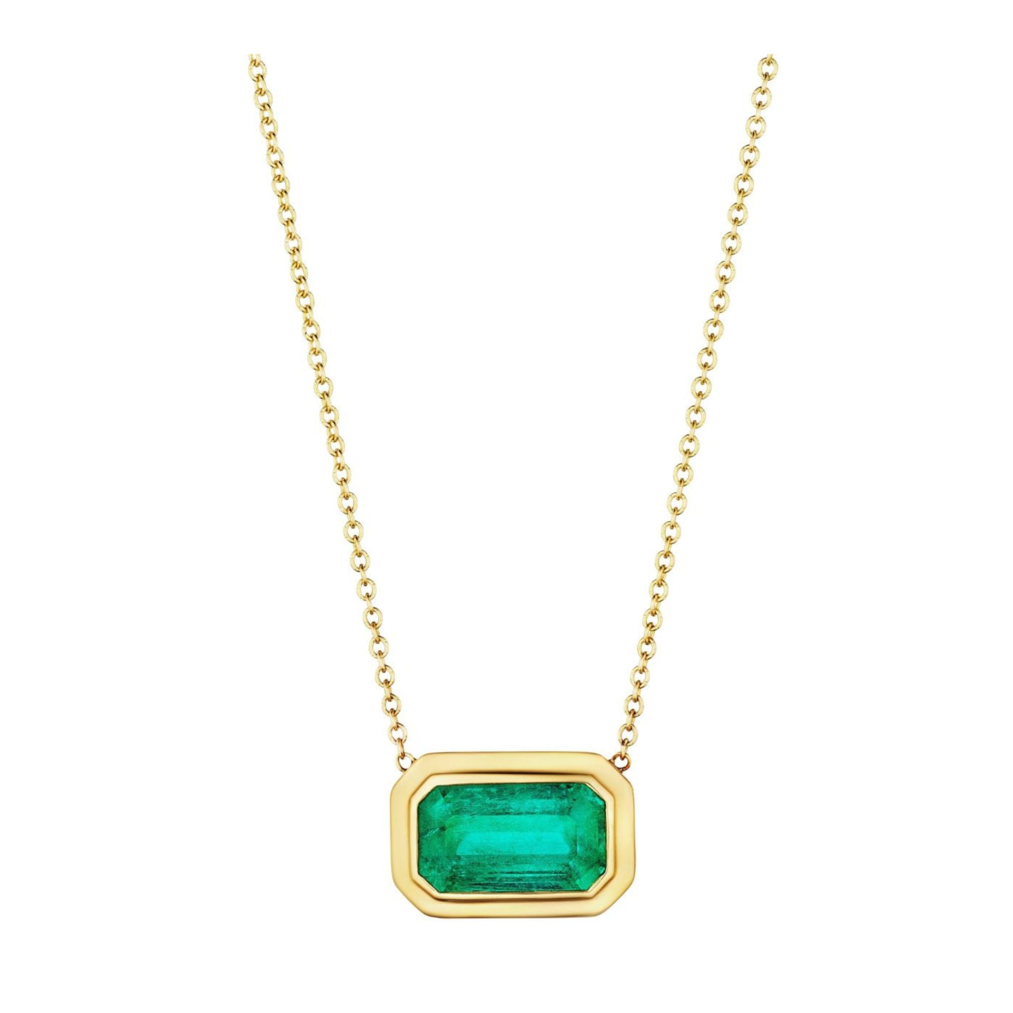 East-West Double Bezel Set Pendant with Emerald Cut Emerald in Yellow Gold, featuring a Colombian emerald gemstone in an elegant double bezel setting on a gold chain, displayed on a white background.