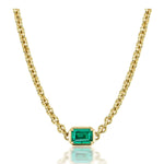 Chain Necklace in Yellow Gold with an emerald-cut emerald set in a simple gold bezel and centered on the chain, photographed against a white background.