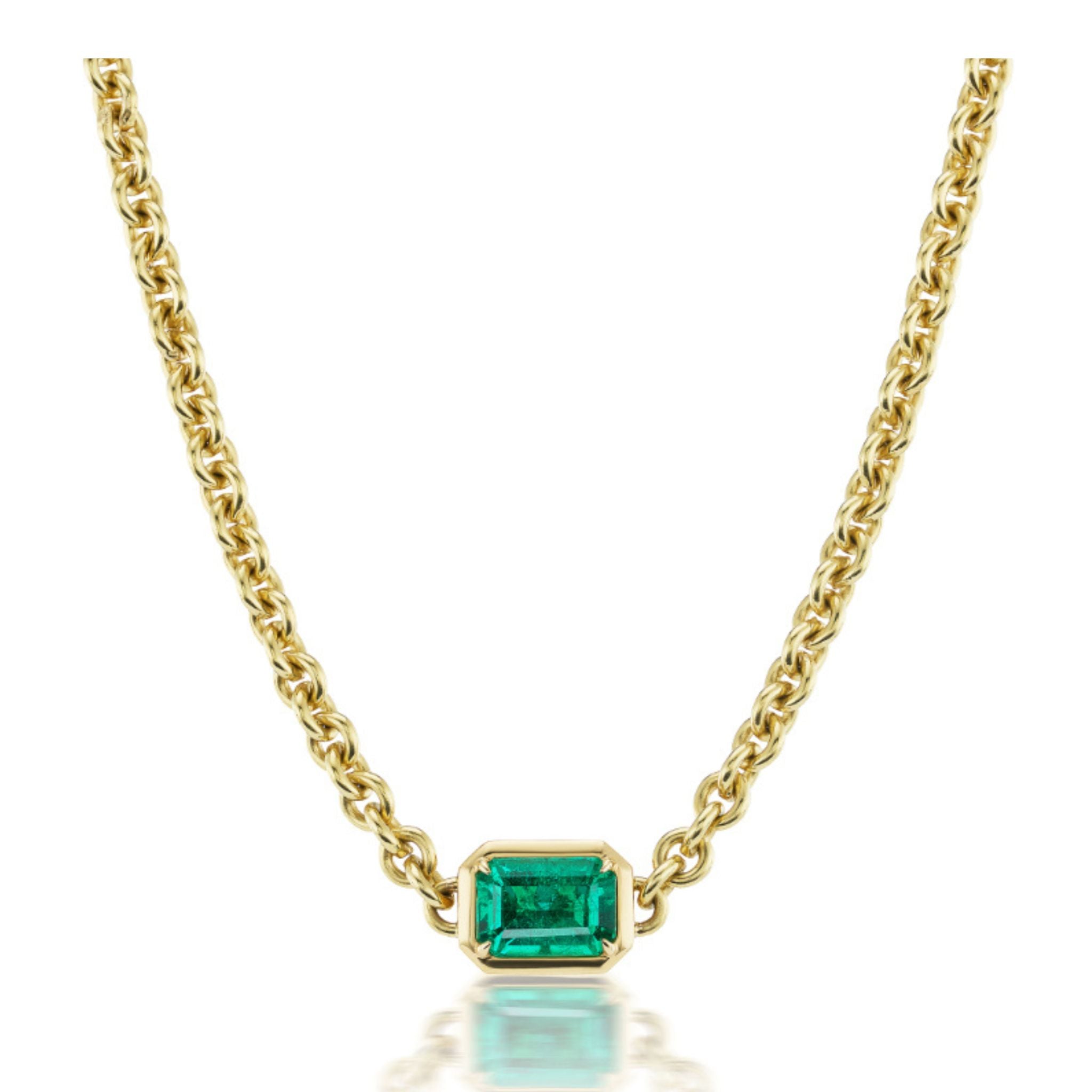 Chain Necklace in Yellow Gold with an emerald-cut emerald set in a simple gold bezel and centered on the chain, photographed against a white background.
