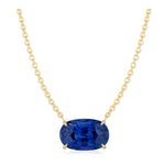 East-West Oval Sapphire Pendant in Yellow Gold, featuring an 18k yellow gold chain necklace with an oval sapphire gemstone held by four prongs, displayed on a white background.