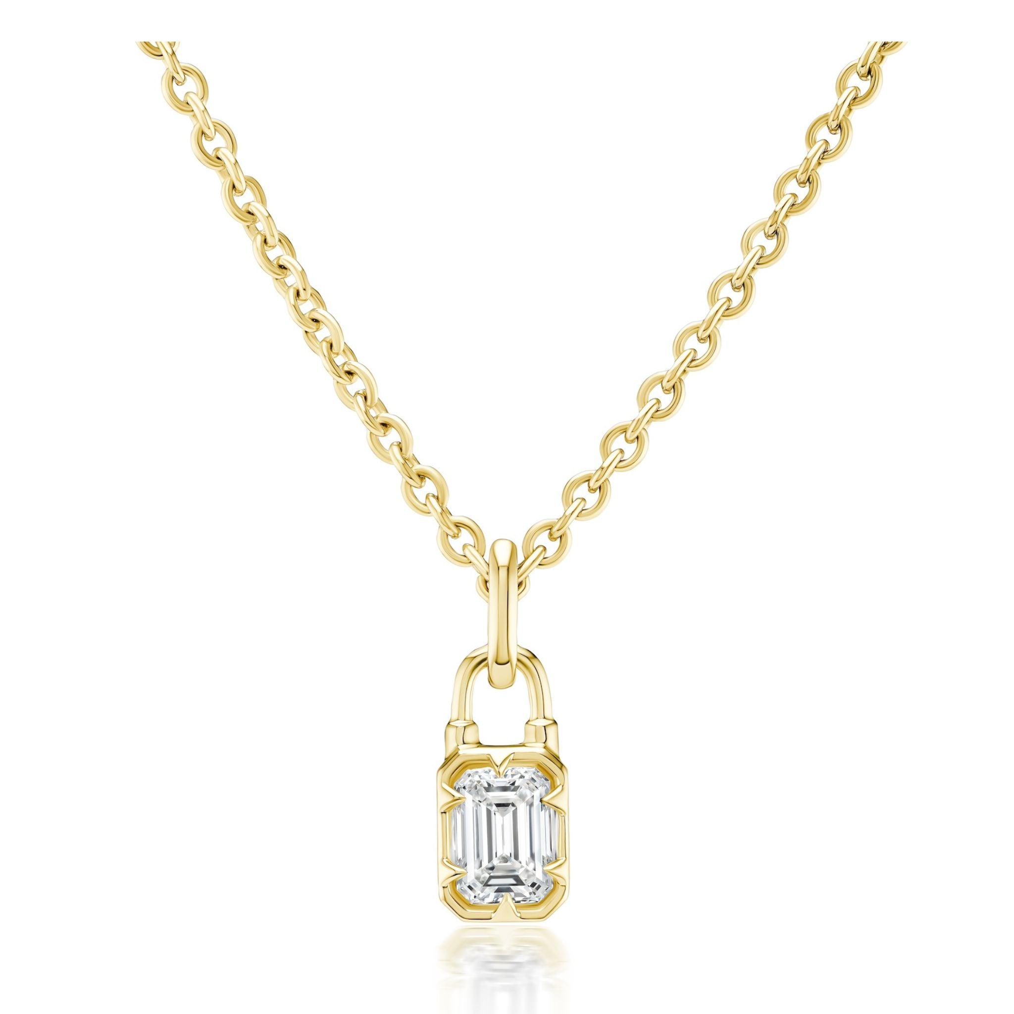 Collet Set Locket Motif Diamond Pendant Necklace with a gold chain featuring a lock-shaped pendant, highlighted by a rectangular, emerald-cut clear diamond at its center. The polished yellow or white gold necklace is displayed against a white background, showcasing both the elegant chain and the striking pendant.