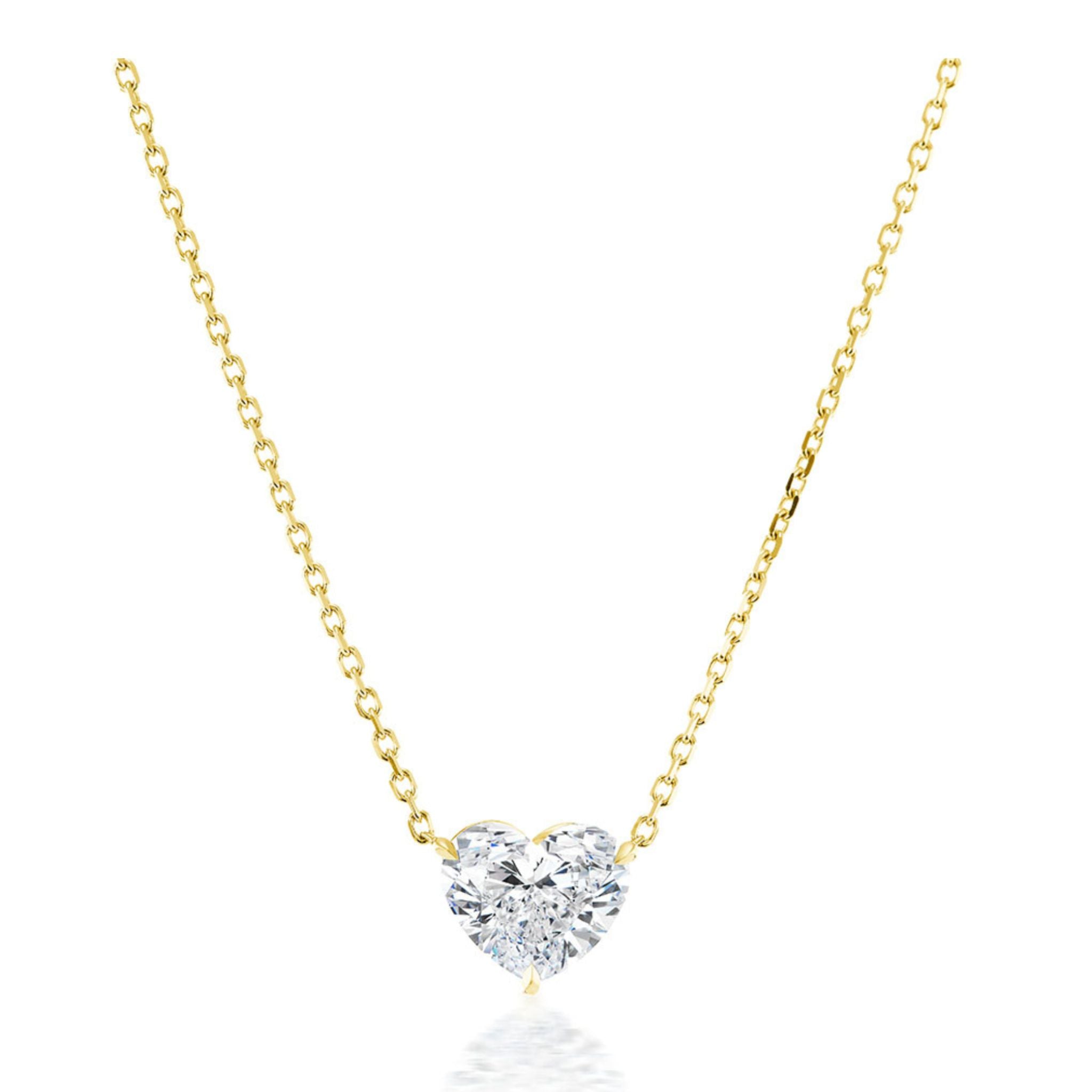 The Heart-Shaped Diamond Solitaire Pendant, crafted in 18k gold, showcases an F color SI2 clarity heart-shaped diamond and is displayed against a white background.