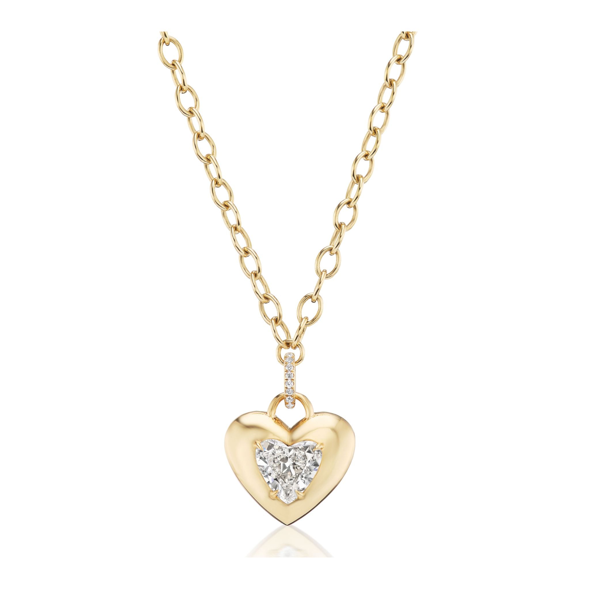 Burnish Set Heart Shape Diamond Pendant: This gold chain necklace features a shiny heart-shaped pendant with a central sparkling diamond and three small accent diamonds above it. The background is plain white.
