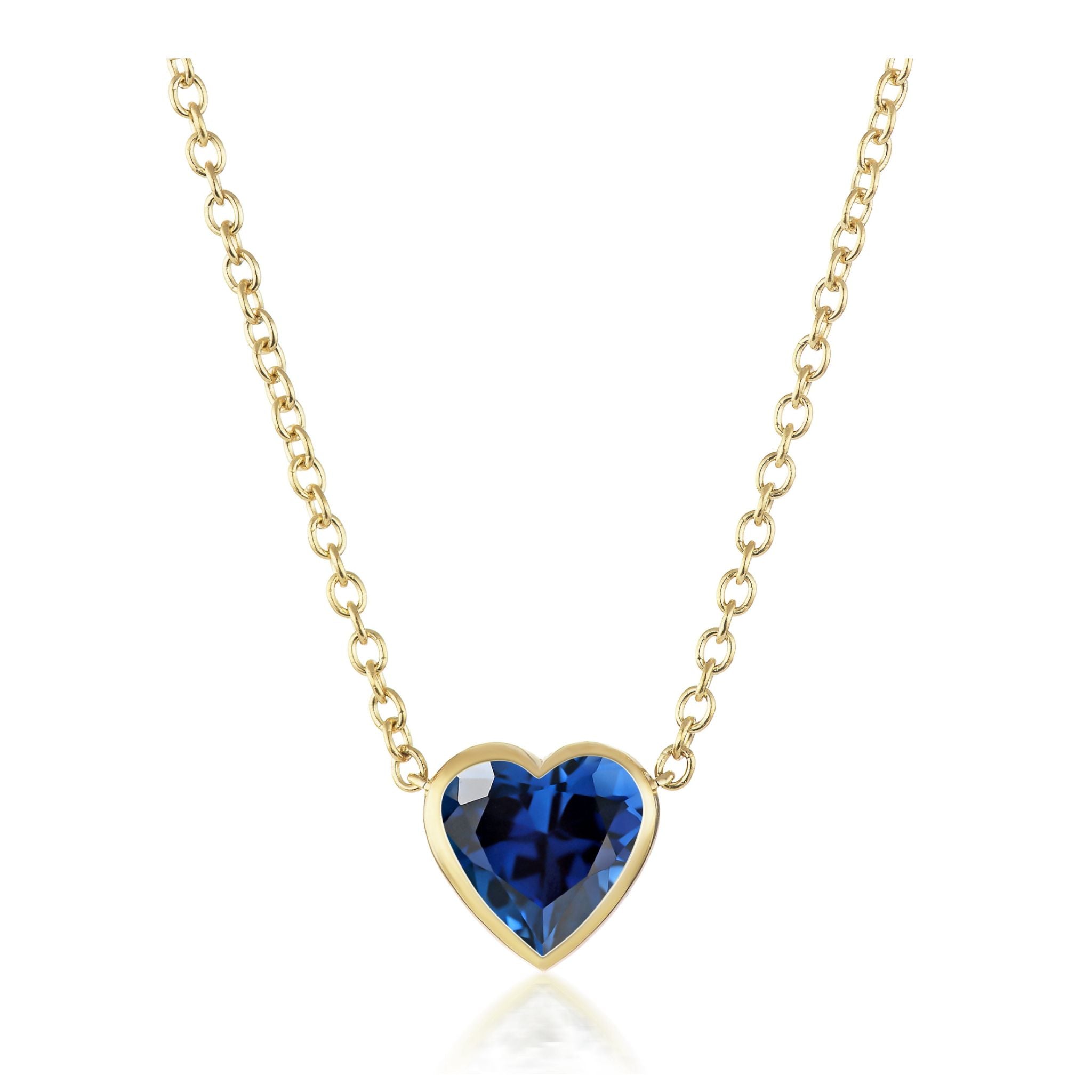 Bezel Set Heart Shape Blue Sapphire Pendant in Yellow Gold, featuring a gold chain and heart-shaped blue sapphire set in 18k yellow gold.
