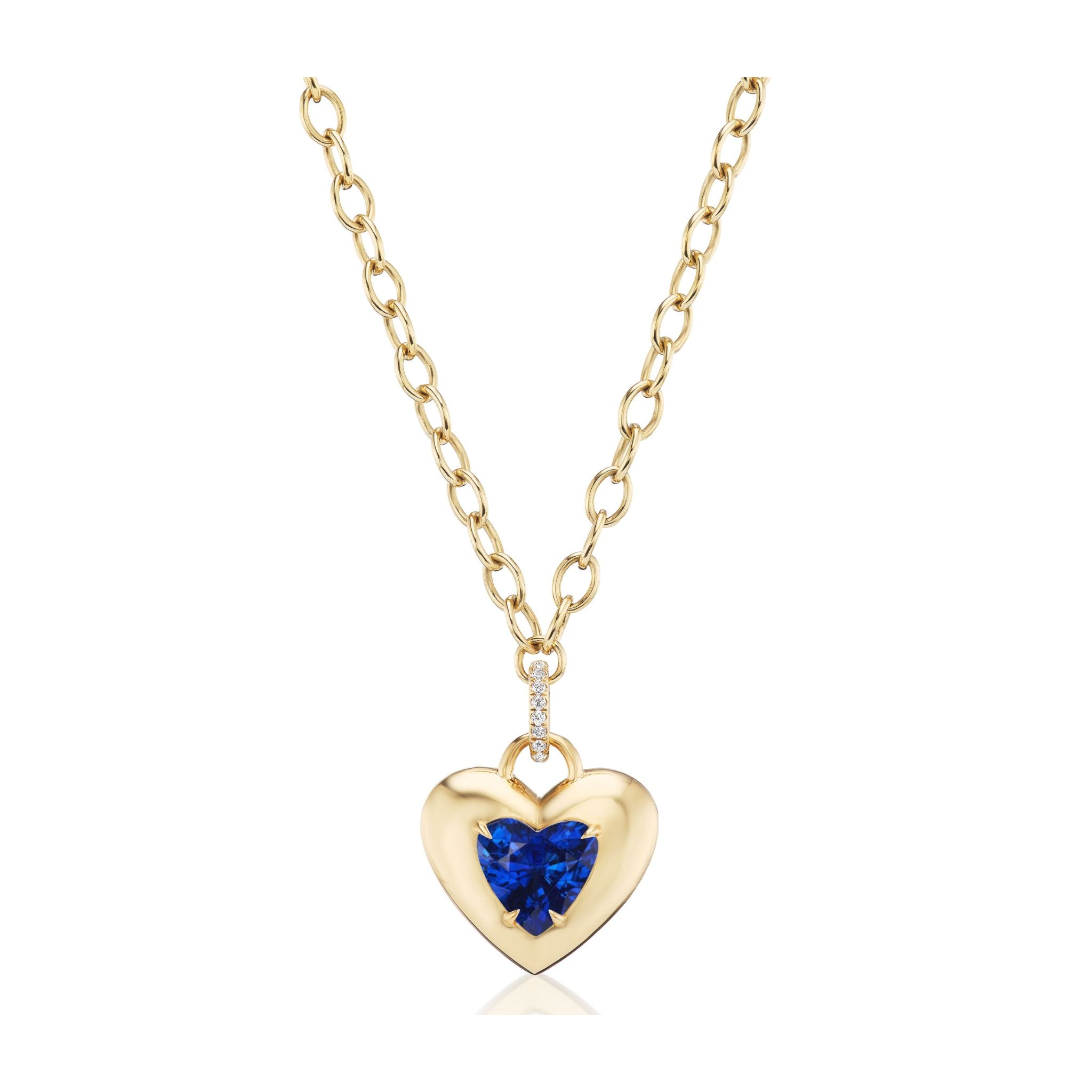 Collet Set Heart Shape Blue Sapphire Pendant in Yellow Gold displayed against a white background, featuring an 18K yellow gold chain necklace with a heart-shaped blue sapphire center and small diamonds on the bail.