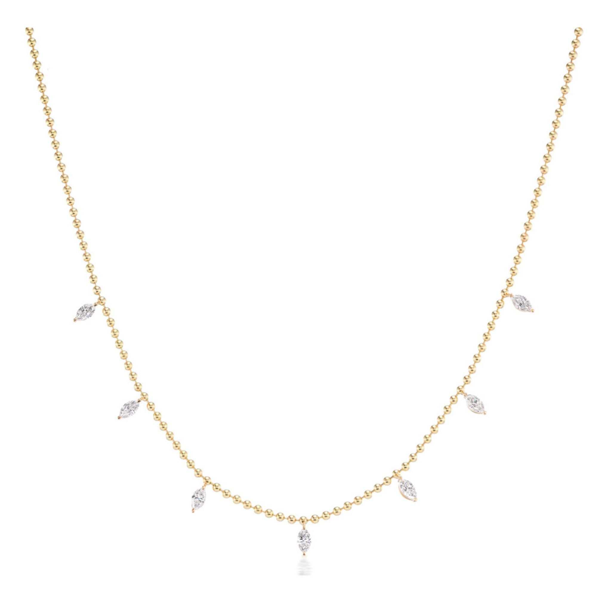 The Spike Ball Chain Necklace with Marquise Diamonds is a delicate 18k gold necklace featuring seven evenly spaced marquise-shaped diamond charms that hang gracefully along the front, perfect for adding a touch of elegance to your collection.