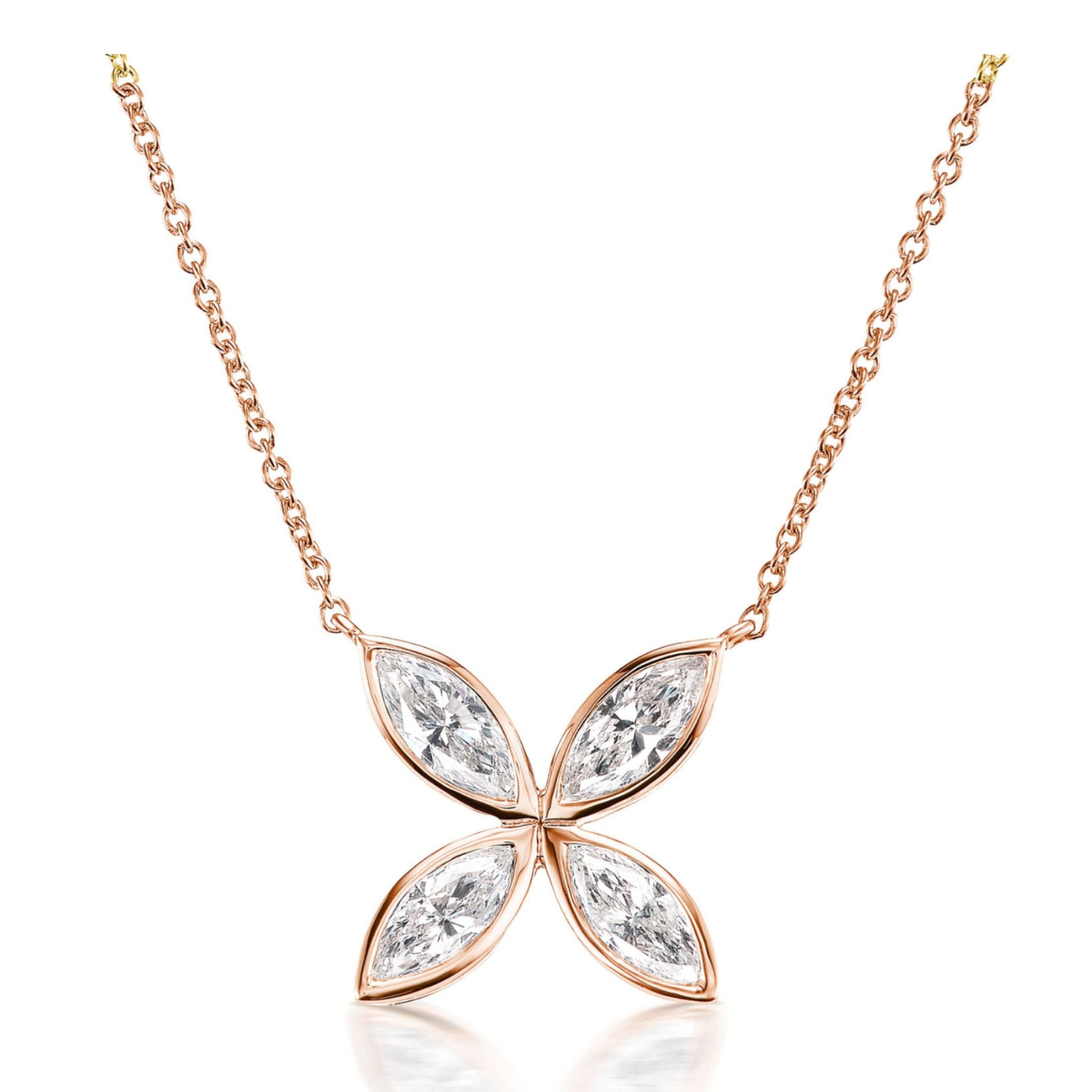 Introducing the Bezel Set Marquise Diamond Floral Pendant: an exquisite necklace crafted in luminous 18k gold, featuring a pendant shaped like a four-petal flower. Each petal is adorned with a bezel-set, marquise-cut diamond that captures and reflects light beautifully. Suspended from an elegant 18-inch chain, this piece dazzles with the brilliance of its sparkling marquise diamonds.