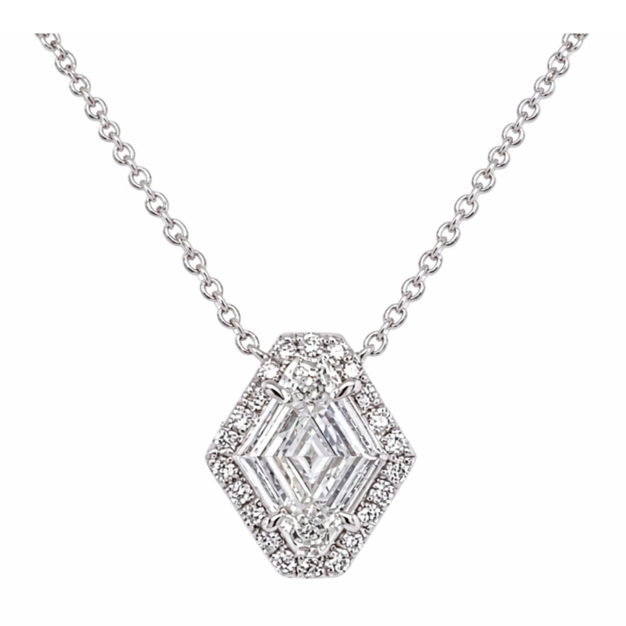 The North-South Shield Diamond Necklace with Pavé Halo in White Gold is an 18-inch silver necklace showcasing a hexagonal pendant with clear, shield-cut diamonds at the center, surrounded by a halo of small round brilliant pavé-set diamonds, and suspended from a delicate chain.