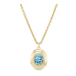 Pavé Oval Cut Aquamarine Collet Pendant in Yellow Gold featuring a large, light blue oval-cut Aquamarine gemstone encircled by pavé-set clear stones, suspended from a shimmering 18K yellow gold chain and displayed against a white background.