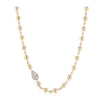 Garland Chain Necklace in Yellow Gold with East-West Set Pear Diamond, featuring evenly spaced round gold beads connected by small gold links along a delicate 18k yellow gold chain and highlighted with a horizontally set teardrop-shaped pear diamond pendant.