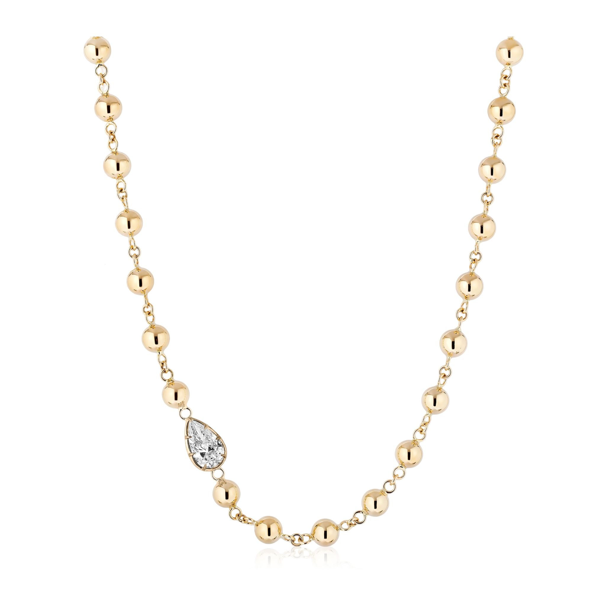 Garland Chain Necklace in Yellow Gold with East-West Set Pear Diamond, featuring evenly spaced round gold beads connected by small gold links along a delicate 18k yellow gold chain and highlighted with a horizontally set teardrop-shaped pear diamond pendant.