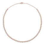 An Octagonal Bezel Set Tennis Necklace in 18k rose gold, featuring a continuous line of round brilliant diamonds of SI1 clarity, each set in an octagonal bezel and evenly spaced, finished with a clasp at the top.