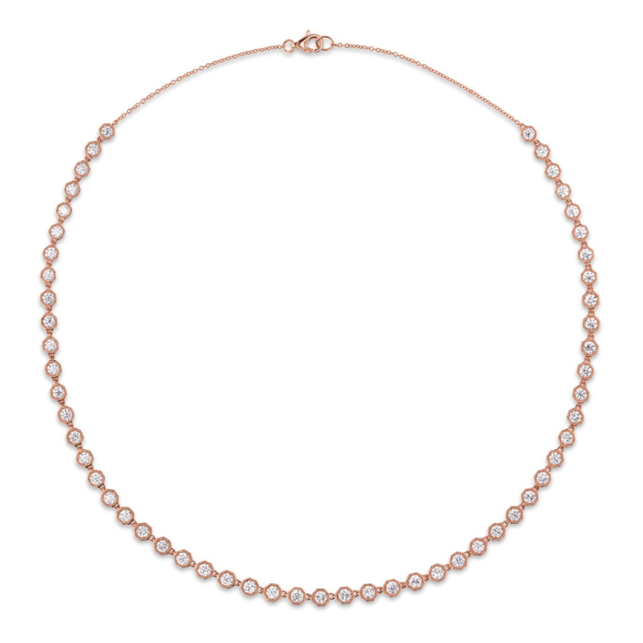 An Octagonal Bezel Set Tennis Necklace in 18k rose gold, featuring a continuous line of round brilliant diamonds of SI1 clarity, each set in an octagonal bezel and evenly spaced, finished with a clasp at the top.