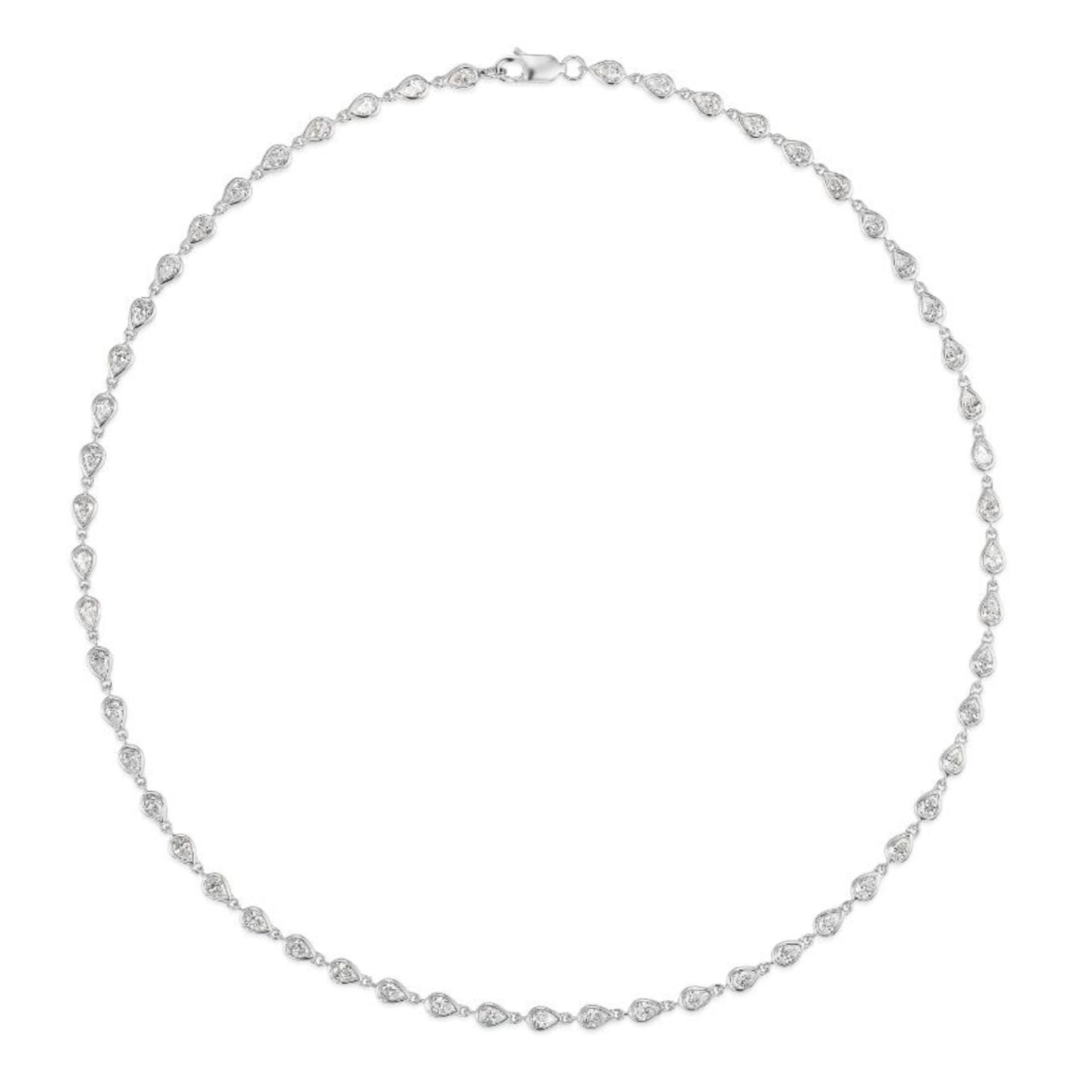 The Chasing Pears Diamond Garland Necklace is a delicate 18K gold piece featuring evenly spaced, pear-shaped diamonds set along a slender metal chain, shown in a circular arrangement on a white background.