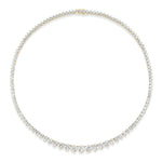 The Medium Graduated Round Diamond Tennis Necklace is crafted in 18k gold and showcases a delicate row of round, graduated white diamonds that increase in size toward the center and taper back toward the clasp, creating a refined and symmetrical design.
