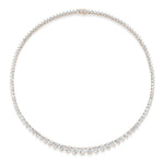 The Medium Graduated Round Diamond Tennis Necklace features a thin, delicate 18k gold chain, adorned with round diamonds in a graduated design—showcasing larger diamonds at the front and smaller ones along the sides.