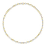 A Medium Hexagon Bezel Set Diamond Tennis Necklace in yellow gold, featuring round diamonds set in distinctive hexagon bezels, forms a continuous and elegant circle against a white background.