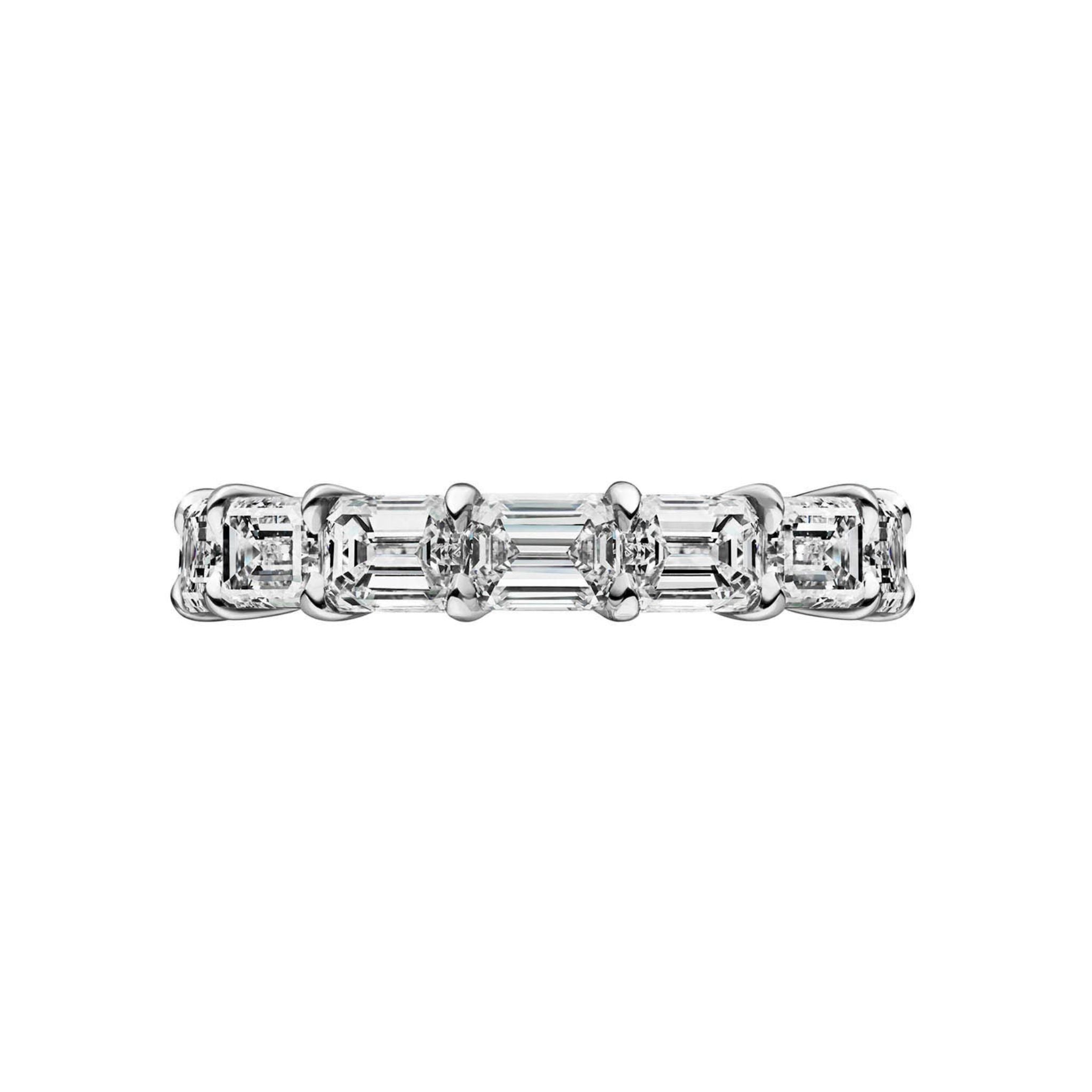 The East-West Emerald Cut Diamond Eternity Band features VVS1 clarity diamonds set horizontally in white gold or platinum, creating a sleek and elegant look.