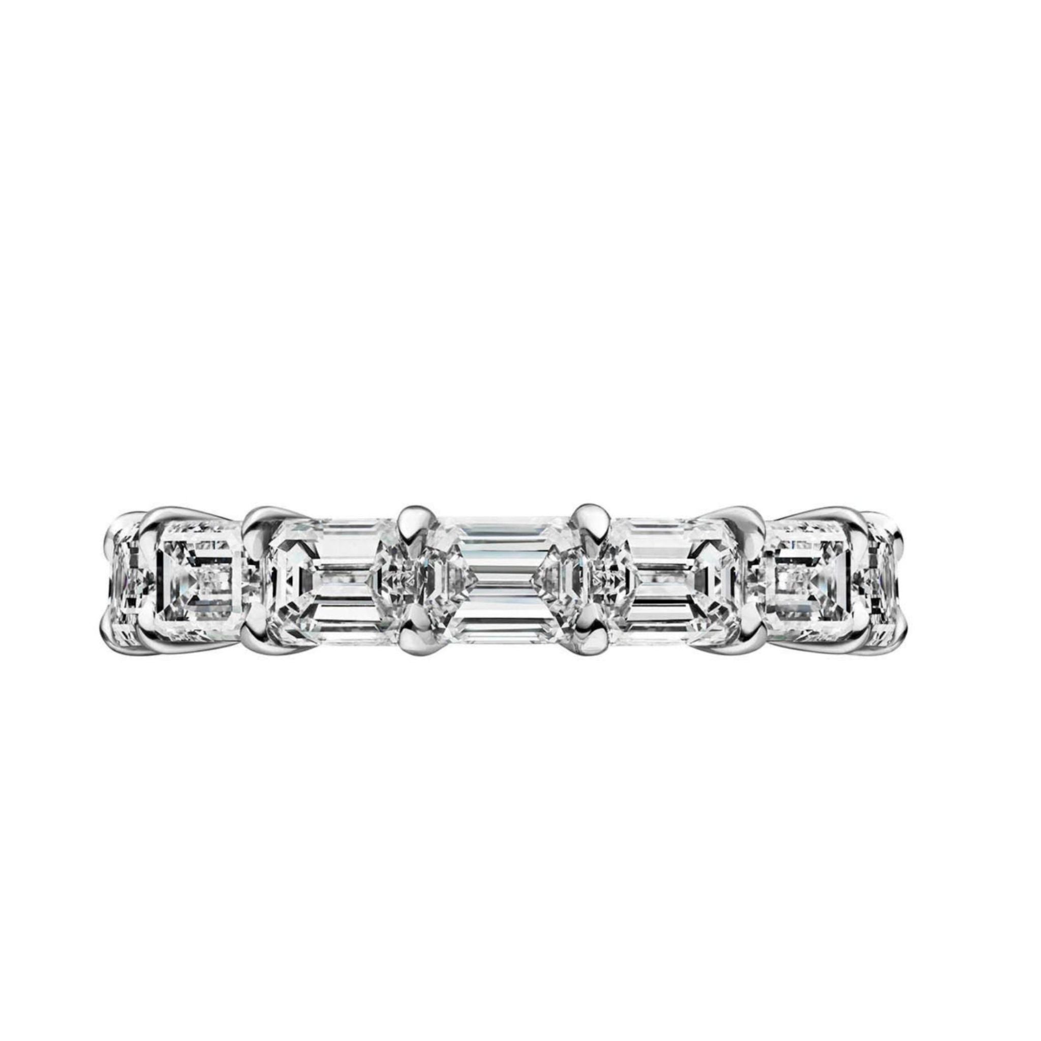 The East-West Emerald Cut Diamond Eternity Band features five rectangular emerald-cut VVS1 diamonds set in a row on white gold or platinum, shown from the side against a white background.