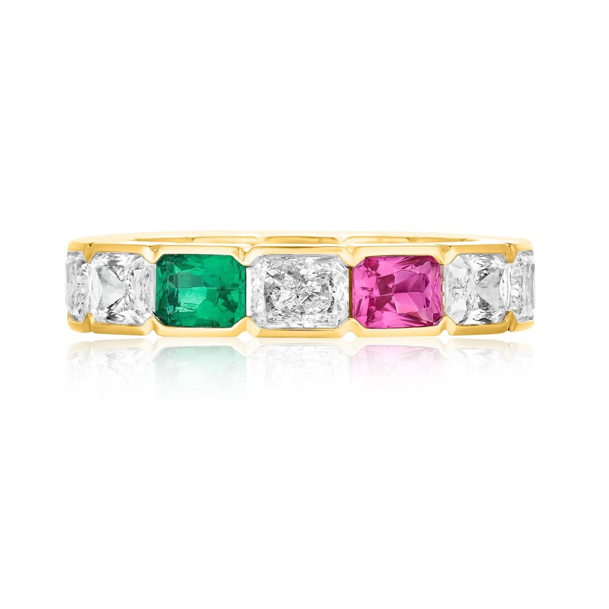 The East-West Half-Bezel Set Radiant Cut Diamond, Emerald, and Sapphire Eternity Band in Yellow Gold features alternating stones in a symmetrical, reflective design.