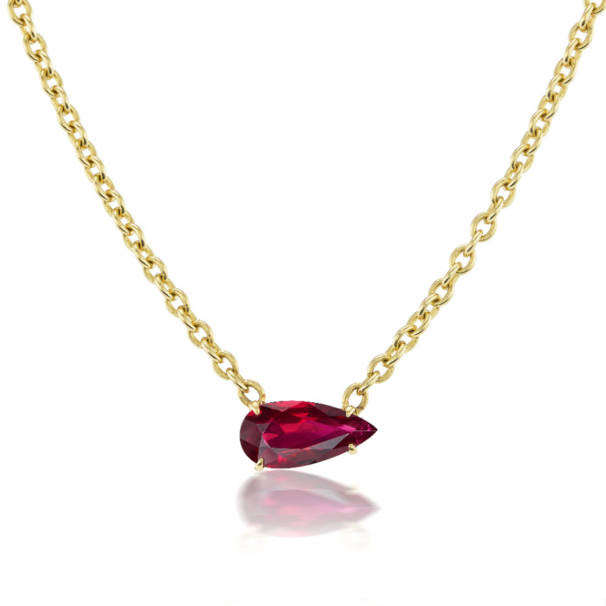 The East-West Pear Ruby Solitaire Pendant in Yellow Gold features an 18K gold chain with a pear-shaped ruby pendant, showcased against a white background.