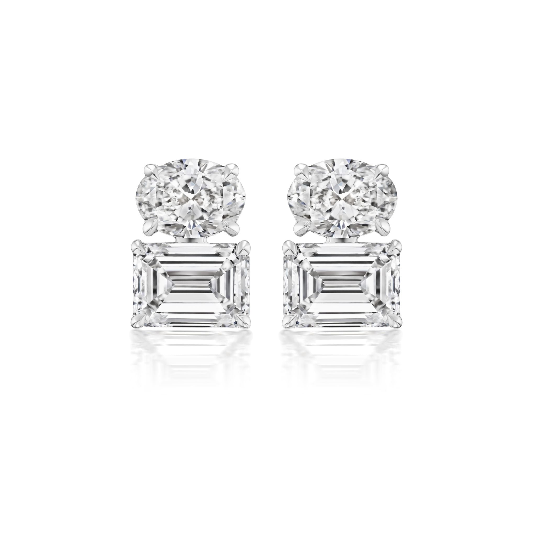 A pair of East-West Set Oval and Emerald Cut Diamond Studs in white gold is displayed against a white background.