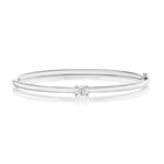 An elegant East-West Oval Solitaire Diamond Bangle crafted in 18K yellow gold, showcasing a single oval-cut solitaire diamond at the center, displayed on a white background with a soft reflection beneath.