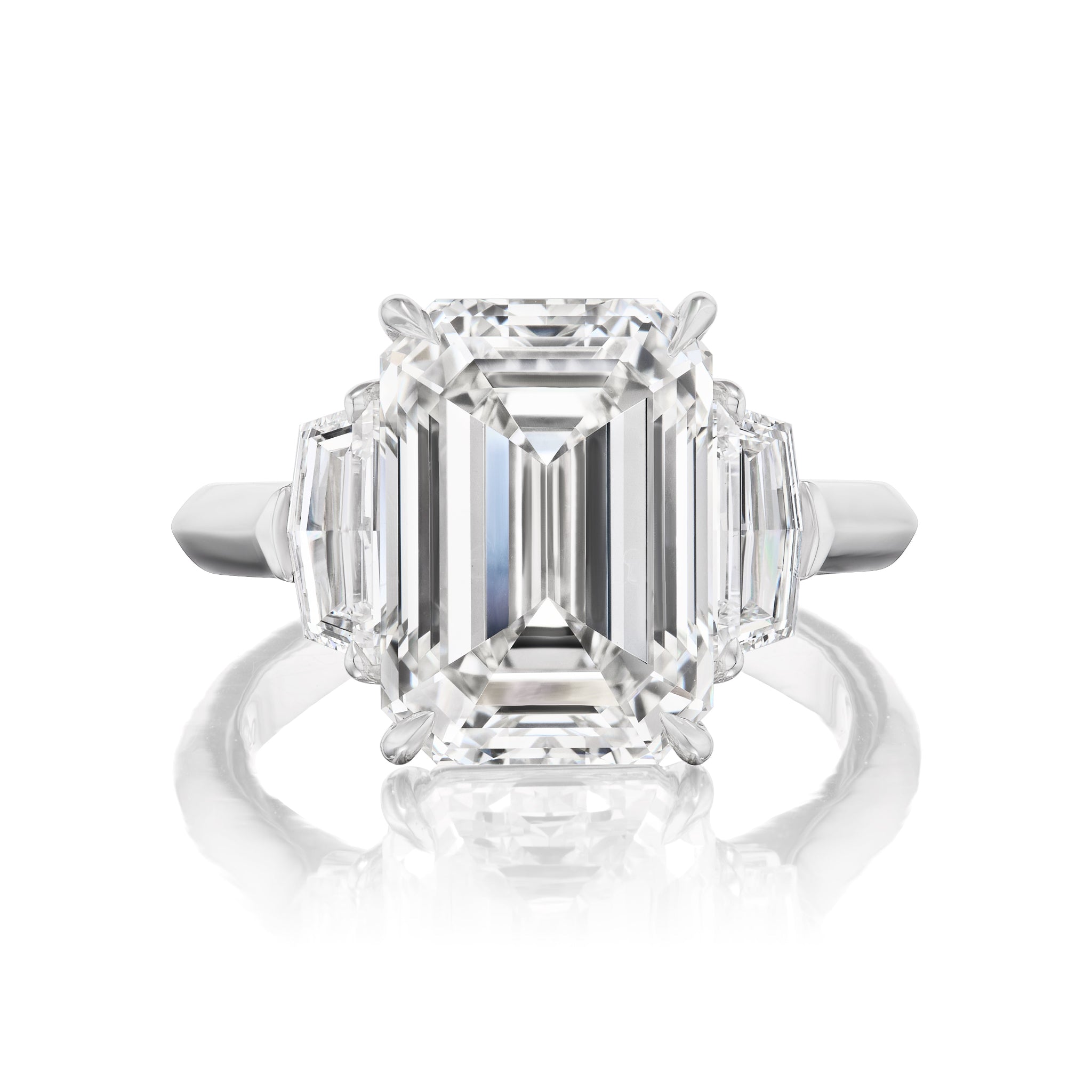 The Emerald Cut Diamond Engagement Ring with Cadillac Side Stones in White Gold features a central emerald-cut diamond accented by Cadillac-cut side stones, all set in elegant white gold.