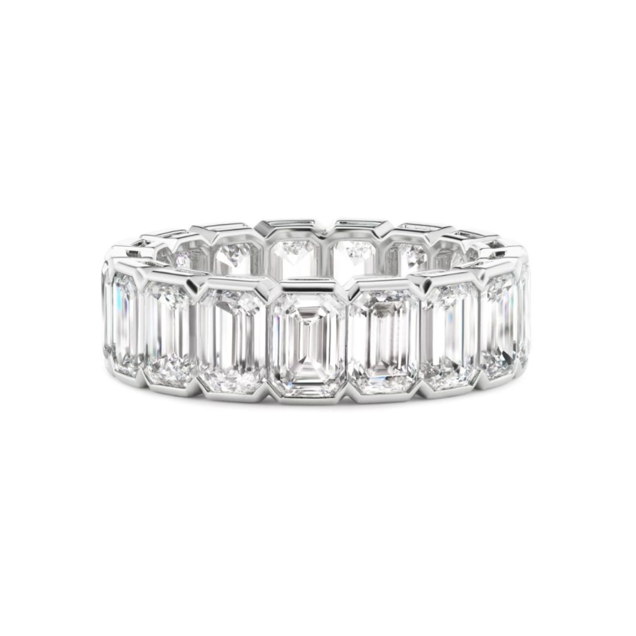 The Half Bezel Emerald Cut Diamond Eternity Band showcases emerald-cut diamonds encircling the band in an elegant half bezel setting, offering a continuous and radiant design—ideal for those seeking exquisite celebration rings or timeless bridal rings.